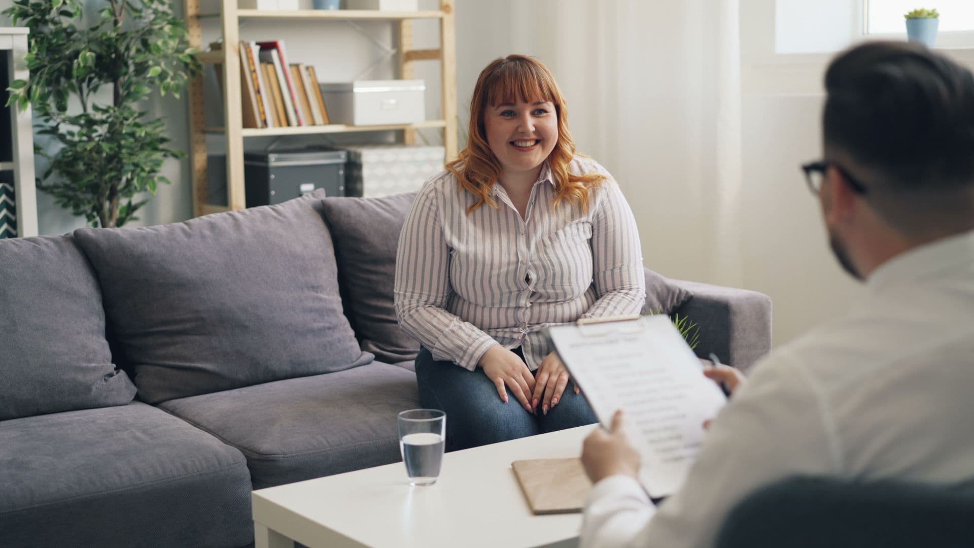 A client smiling during an uplifting session with her counselor